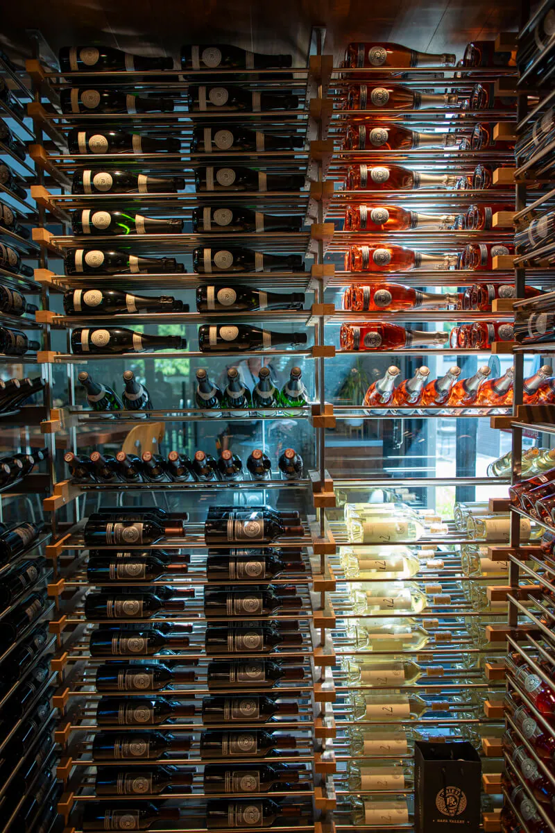 display of wine bottles on wall