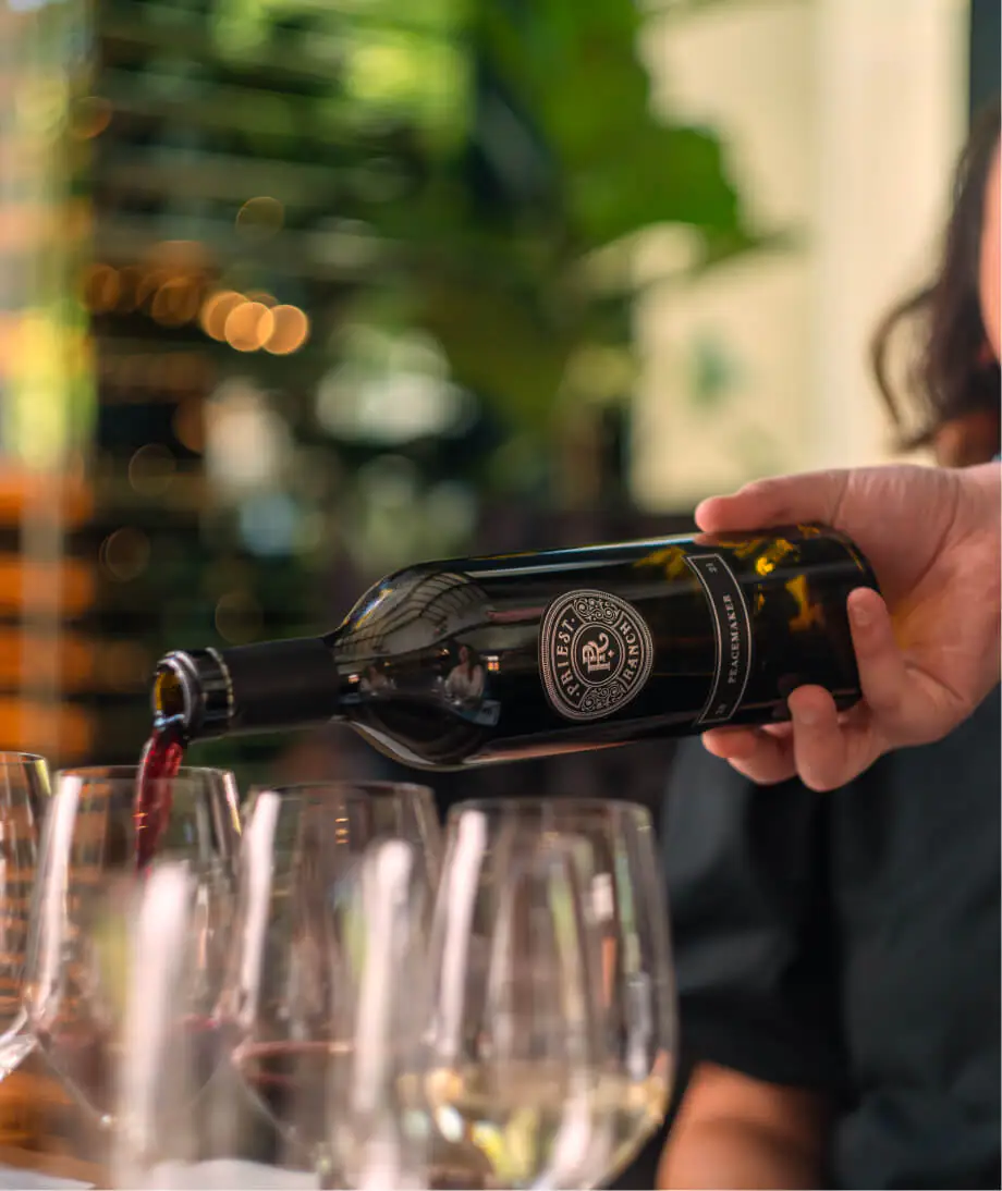 bottle pouring wine in glass