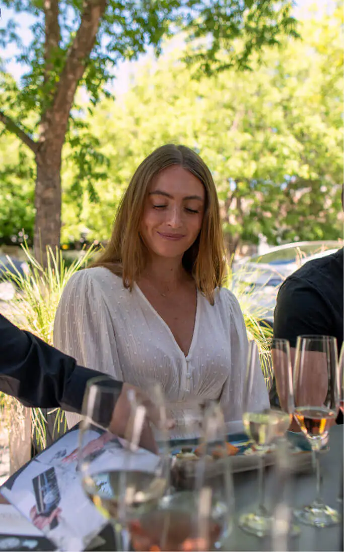 woman looking down on glasses of wine