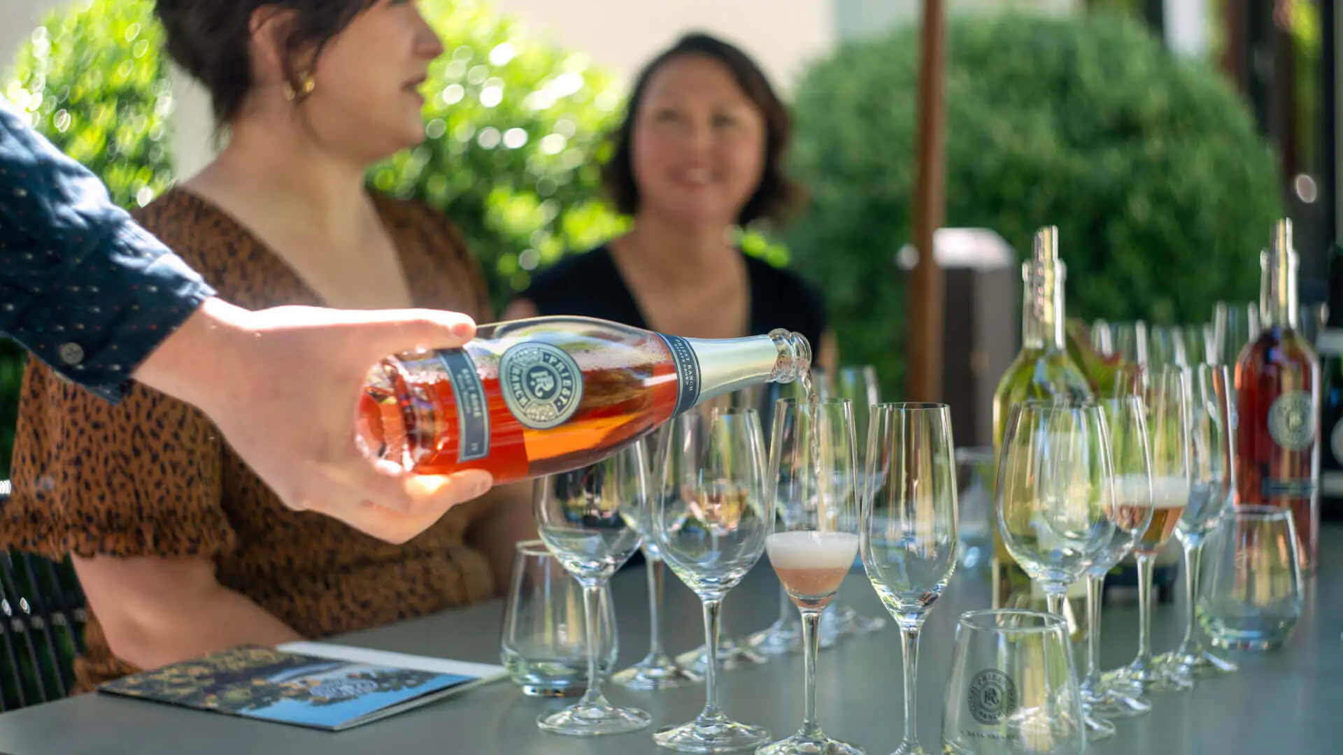 rose bottle pouring into glasses