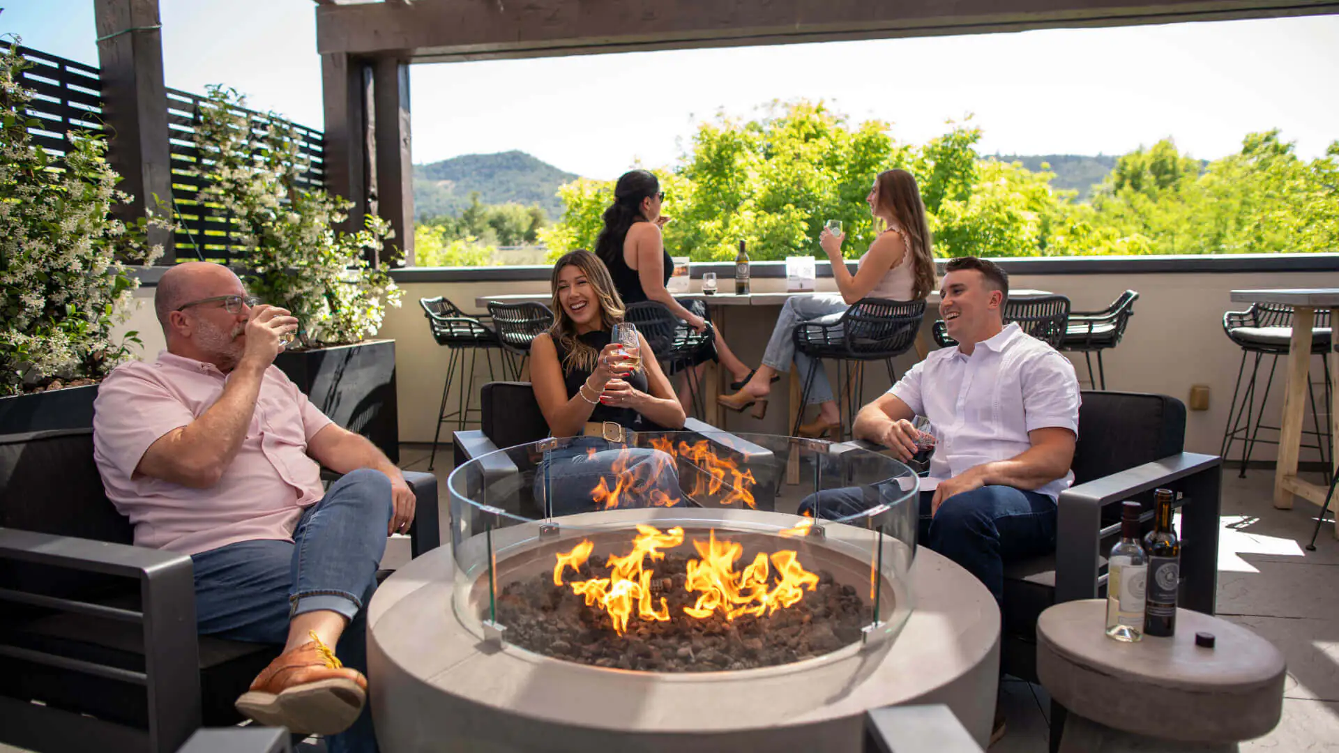 people gathered around a modern bonfire