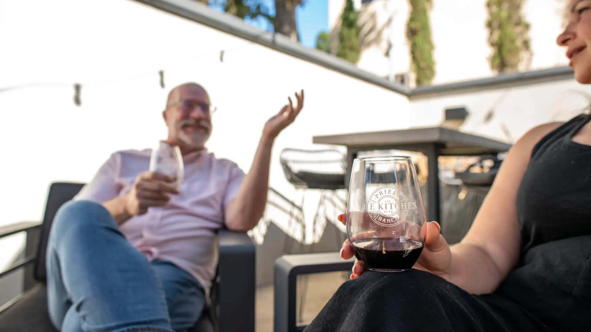 people chatting with wine glasses